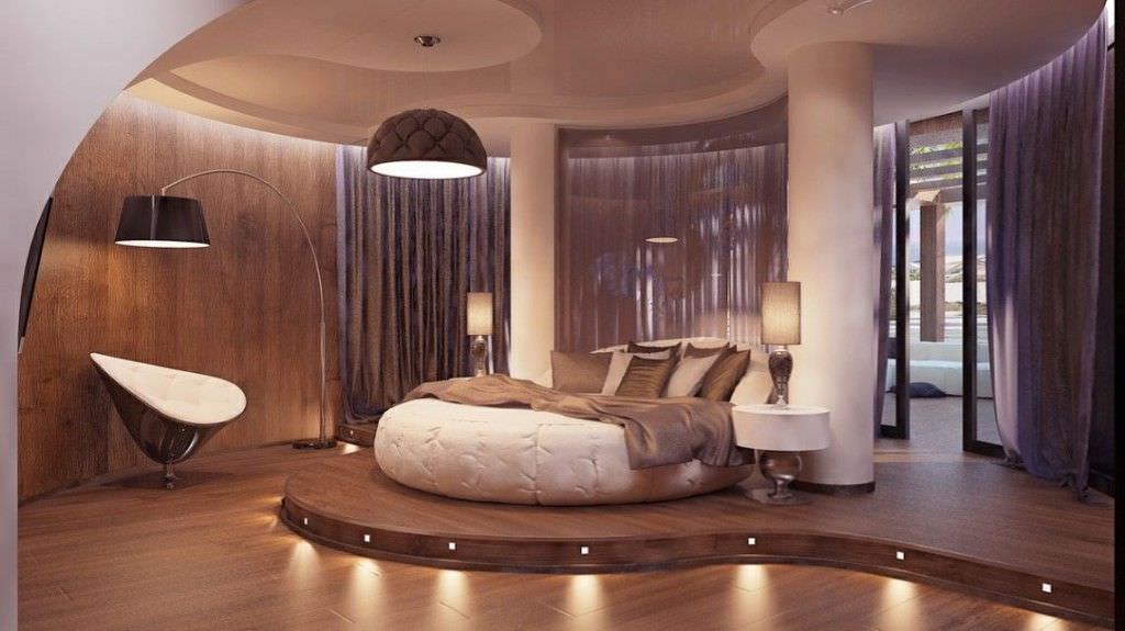 تخت خواب گرد دو نفره سفید که برای ایجاد هارمونی، در کنار آن صندلی، پاتختی، آویز و لوستر دایره ای و گرد استفاده شده است
